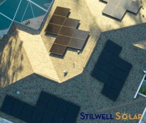 Solar panels on the roof of a home with a pool.