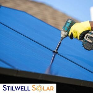 Man installing solar panels on a roof.